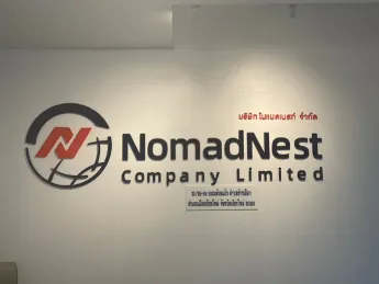 NomadNest logo wall at the Chiang Mai office